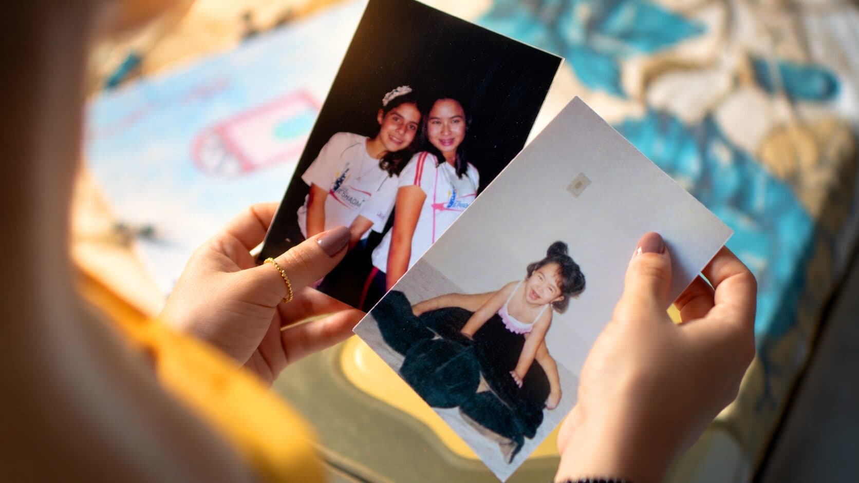 Hands holding old family photos